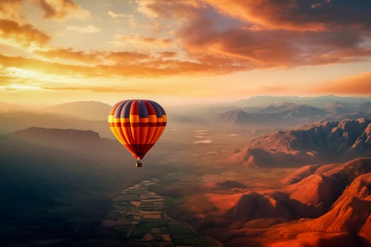 A colorful hot air balloon floats in sky over a desert mountain landscape at sunset with orange and blue skies in the background. Travel journey adventure beauty of nature concept