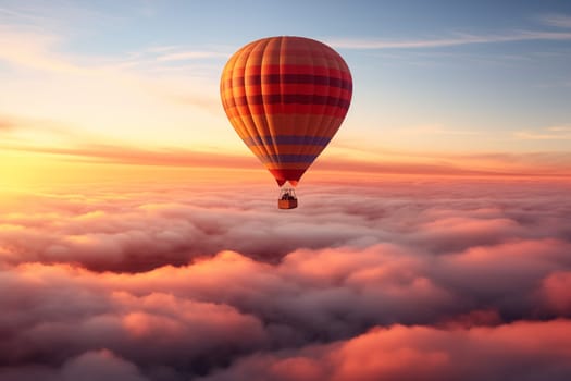 Colorful hot air balloon floats over a sea of clouds at sunset at sunset with orange and blue skies in the background. Travel journey adventure beauty of nature concept