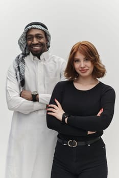 Muslim entrepreneur and a contemporary red-haired girl strike a pose together against a clean white background, embodying confidence, diversity, and a dynamic entrepreneurial spirit in their partnership.