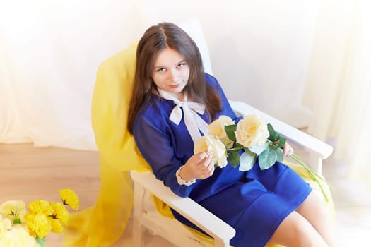 Beautiful sweet manager girl in romantic business dress with fresh flowers in office. Young businesswoman on International Women's Day on March 8