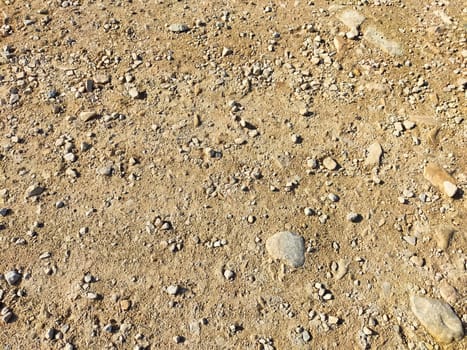 Texture and background of podzol soil with pebbles. Abstract Earth and stone as place for text and copy space. Top view