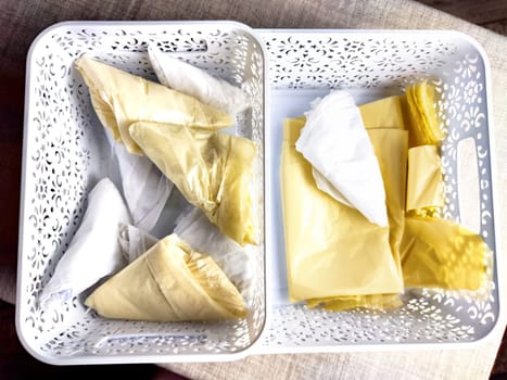 Plastic bag folded into triangle for storage. Ways of storing and laying at home