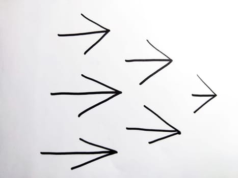 Pack drawn black marker arrows. The concept of business, choosing direction, moving forward. Abstract sign, background, texture. Partial focus, blur