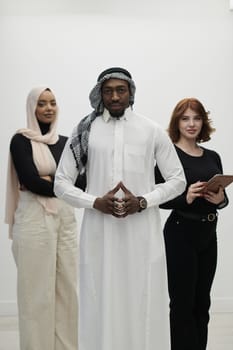 Arabic businessman stands confidently alongside two businesswomen, portraying a poised and diverse team that embodies ambition, innovation, and visionary leadership against a pristine white background.