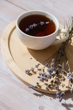 Lavender flowers with herbal cup of tea. Concept of Herbal medicine natural remedy. Organic relieving stress. Healthy beverage fresh delicious floral hot tea. Antispasmodic effect naturopathy concept