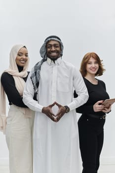 Arabic businessman stands confidently alongside two businesswomen, portraying a poised and diverse team that embodies ambition, innovation, and visionary leadership against a pristine white background.