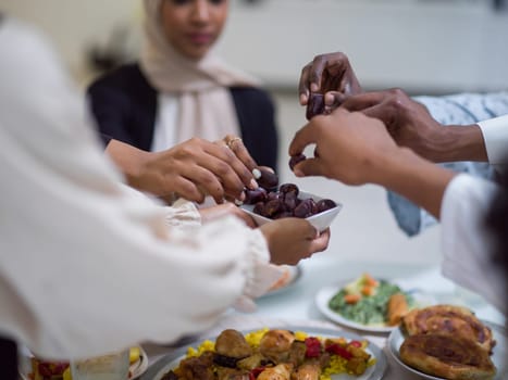 A woman in a hijab extends a platter of dates to her diverse family, creating a scene of unity and joy as they come together to break their fast during the holy month of Ramadan, symbolizing the shared love and spiritual connection within their cultural and religious traditions.