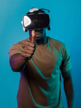 African American man wearing virtual reality glasses expresses satisfaction and impressed delight, gesturing with his hand pointed upward, while standing isolated against a vibrant yellow background, showcasing a positive and contented experience within the immersive virtual realm.