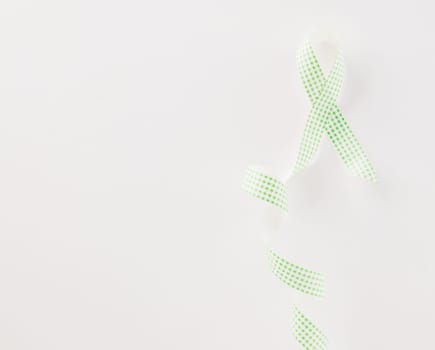 Green awareness ribbon of Gallbladder and Bile Duct Cancer month isolated on white background with copy space, concept of medical and health care support