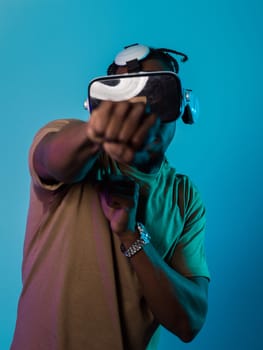 In an avant-garde scene, an African American man engages in cutting-edge virtual reality gaming, utilizing VR glasses to immerse himself in futuristic boxing games, set against a vivid blue background, showcasing the seamless fusion of technology, innovation, and interactive entertainment.