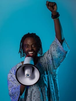 In a powerful and symbolic image, an African American man wears traditional clothing, passionately wields a megaphone against a striking blue background, with his hand raised in the air symbolizing his vocal and cultural empowerment in the pursuit of social justice and equality.