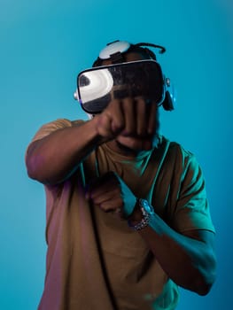 In an avant-garde scene, an African American man engages in cutting-edge virtual reality gaming, utilizing VR glasses to immerse himself in futuristic boxing games, set against a vivid blue background, showcasing the seamless fusion of technology, innovation, and interactive entertainment.