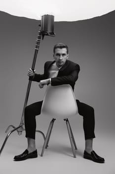 elegant model man in black suit in photostudio. black and white