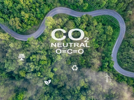 CO2 neutral with aerial view green trees forest background. Carbon neutral concept. Eco friendly. Sustainable and renewable energy. Sustainable resources. Solar and wind power. Renewable energy.