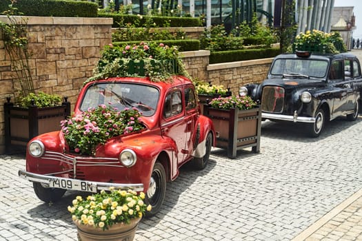 Vintage car decorated with flowers in the photo zone in a romantic style. High quality photo