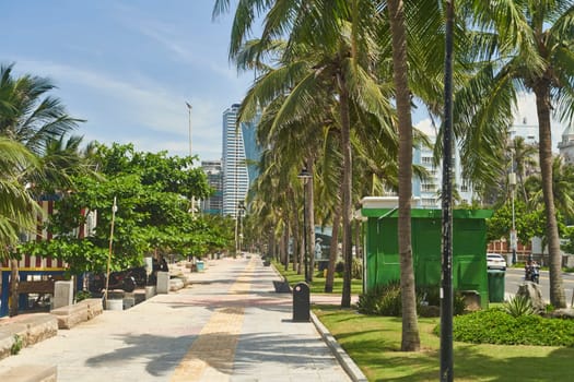 Da Nang, Viet nam - 28.06.2023: Promenade with palm trees and cafes on My Khe beach in Da Nang. High quality photo