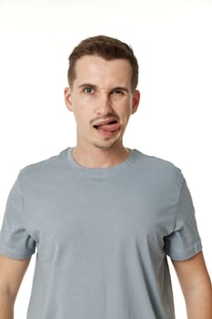 portrait of young funny man grimacing on white background