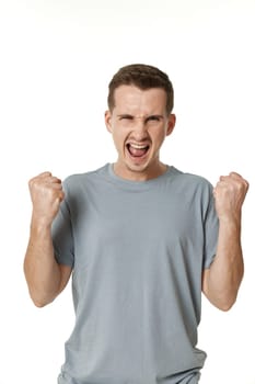 portrait of young man showing victory gesture on white background