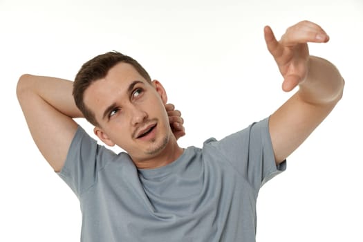 happy guy looking up and pointing up on white studio background