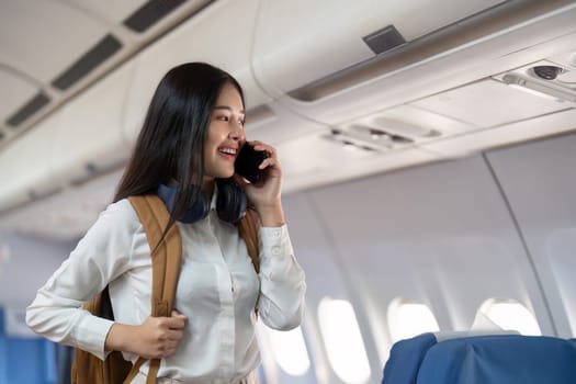 Alone Asian woman passenger traveling by plane. happy traveler on board. Solo travel concept.