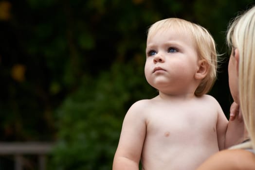 Baby, curiosity and mother outdoor for development with love, mockup or early childhood in backyard of home. Toddler, child and relax for wellness, milestone and exploring with innocence and bonding.