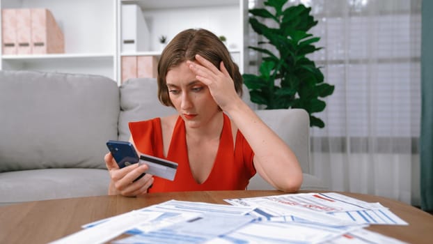 Stressed young woman has financial problems with credit card debt to pay prim from bad personal money and mortgage pay management crisis. Woman worry about financial bankruptcy risk from over spending