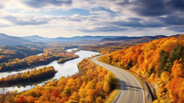 Scenic aerial view of a road passing through the colorful forest at fall. High quality photo
