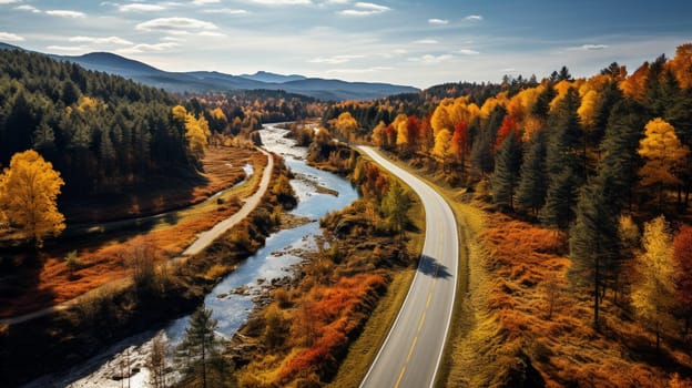 Scenic aerial view of a road passing through the colorful forest at fall. High quality photo