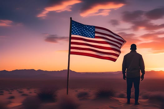 View from the back of a man in nature in front of the US flag at sunset.