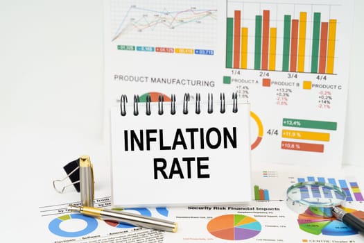 Business concept. On the table are reports with graphs and a notepad with the inscription - Inflation rate