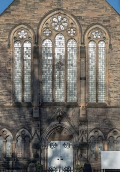Edinburgh, Scotland-Jan 17, 2024 - The sunshine lights through the glass window frame and old wall Exterior architecture of The cathedral Church. Space for text, Selective focus.