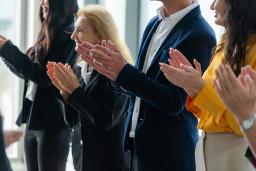 Group of business people clapping hands at successful presentation or conference. Cropped image focus on hand. Diverse male and female clapping hand to congratulate speaker. Side view. Intellectual.