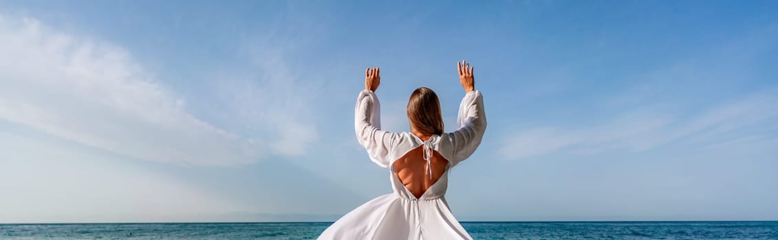 Woman beach white dress flying on Wind. Summer Vacation. A happy woman takes vacation photos to send to friends