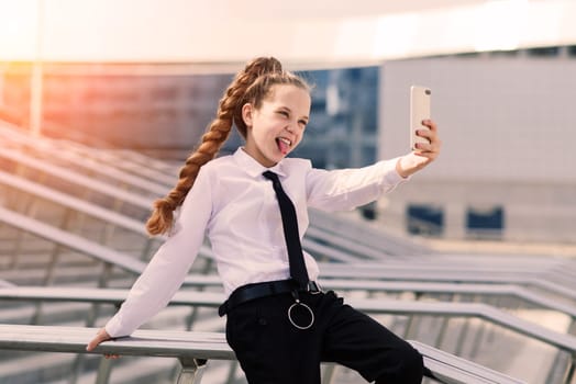 Little school girl having phone talk with friend. Modern life. Living in digital age.