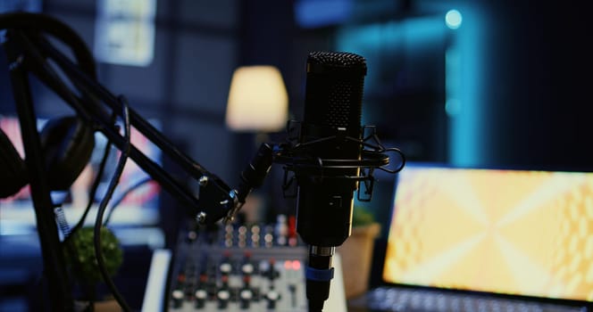 Close up shot of microphone used for podcasts, vlogging and livestreams on vlog channel. Zoom in on professional mic in dimly lit studio used for recording audio during internet show