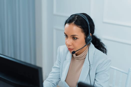 African American young businesswoman wearing headset working in office to support remote crucial customer or colleague. Call center, telemarketing, customer support agent provide service on video call