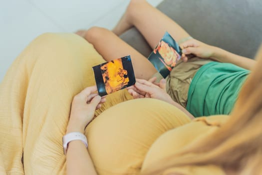 Expectant mother tenderly shares the joy of her unborn baby with her son, showing him heartwarming ultrasound photos of his soon-to-arrive little brother.