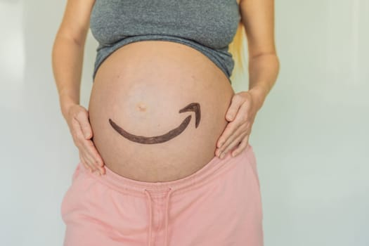 28.01.23, Mexico, Playa del Carmen: Creative concept of an Amazon icon on a pregnant belly, symbolizing the anticipation and delivery of joy, much like the reliable and timely services provided by Amazon. As well as products for pregnant women and babies on Amazon.