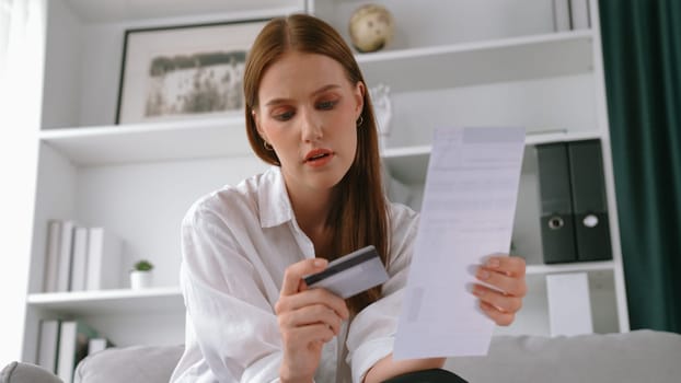 Stressed young woman has financial problems with credit card debt to pay prim from bad personal money and mortgage pay management crisis. Woman worry about financial bankruptcy risk from over spending