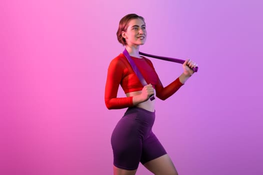 Full body length gaiety shot athletic and sporty young woman with fitness elastic resistance band in standing posture on isolated background. Healthy active and body care lifestyle.