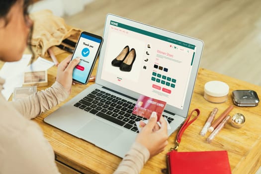 Woman shopping online on internet marketplace browsing for sale items for modern lifestyle and use credit card for online payment from wallet protected by crucial cyber security software