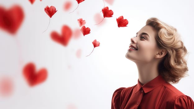 Lovely romantic woman looking at red hearts over white background. Love concept. Valentines day.