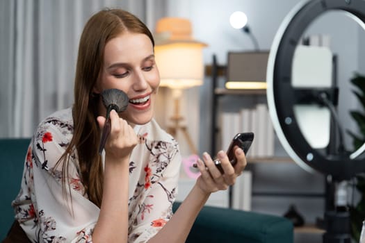 Woman influencer shoot live streaming vlog video review makeup utmost social media or blog. Happy young girl with cosmetics studio lighting for marketing recording session broadcasting online.