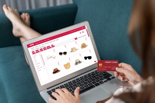 Woman shopping online on internet marketplace browsing for sale items for modern lifestyle and use credit card for online payment from wallet protected by utmost cyber security software