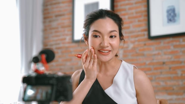 Woman influencer shoot live streaming vlog video review vivancy makeup social media or blog. Happy young girl with cosmetics studio lighting for marketing recording session broadcasting online.