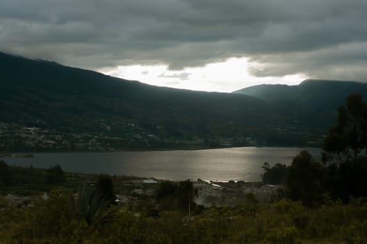 This photo captures the stunning sight of Lake San Pablo with the majestic Andes Mountains in the background in Ecuador.