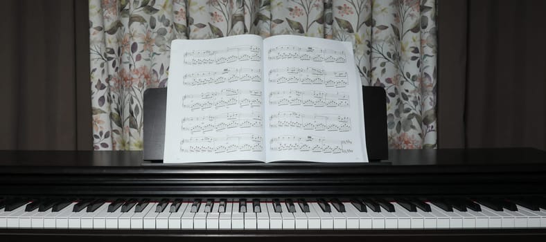 black piano and sheet music, at home. High quality photo