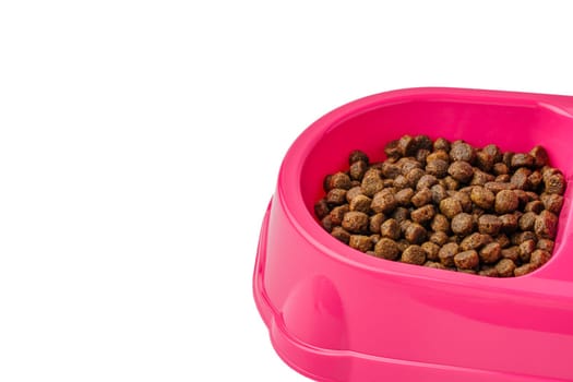 Bowl with dry pet food isolated on white background close up
