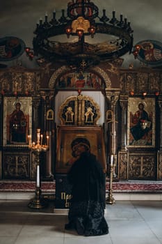 monk kneeling in front of the church icon. High quality photo