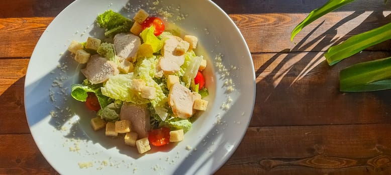 Caesar salad with roasted chicken meat
